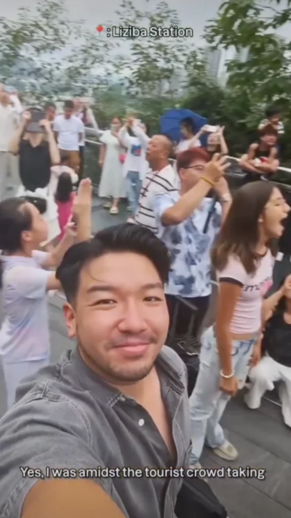 Traveler taking a selfie in a crowd of tourists at Liziba Station, a popular scenic spot